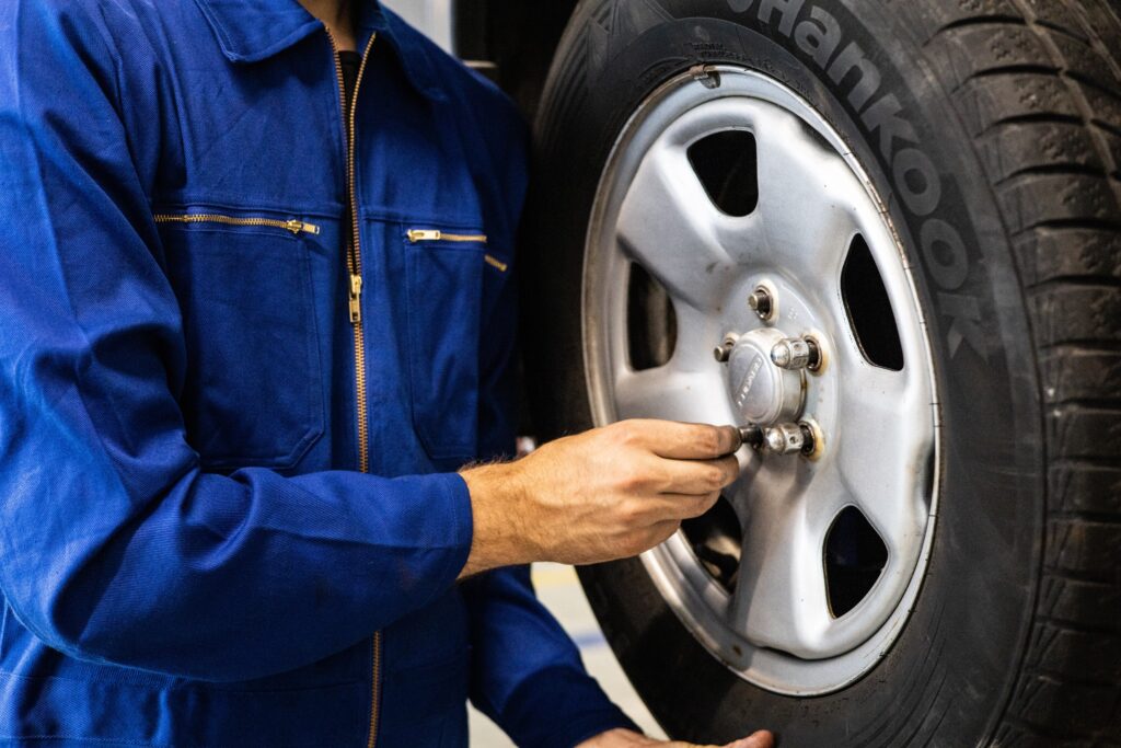A close-up picture of a person fixing a tire