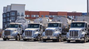 A fleet of Peterbilt trucks lined up in a row