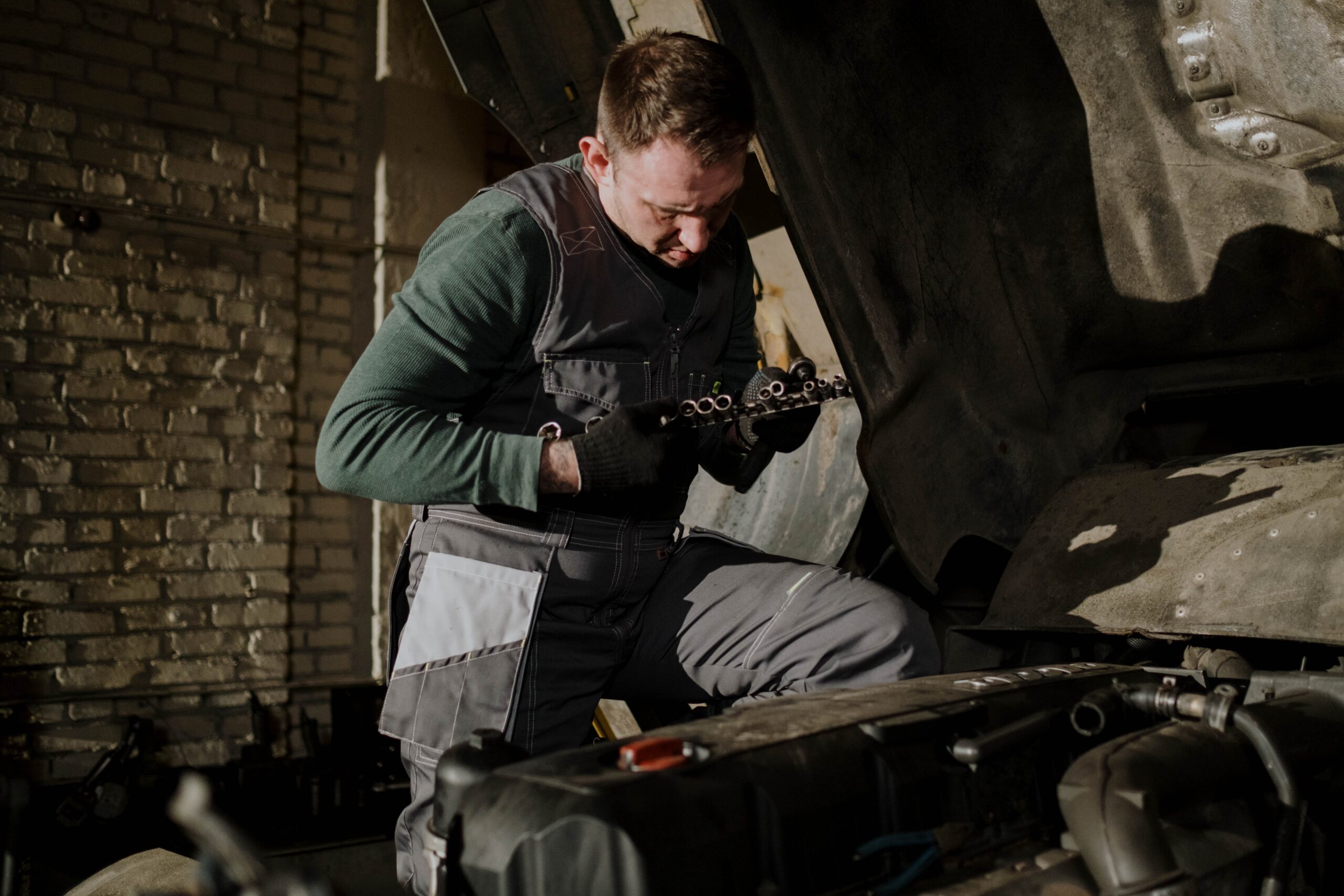 A diesel repair technician holding a gasket