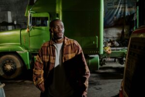A person in front of a semi truck