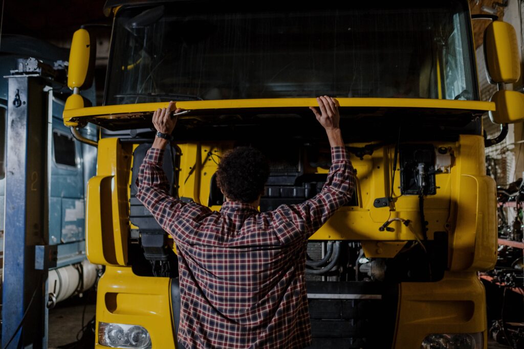 A person opening the hood of a truck 