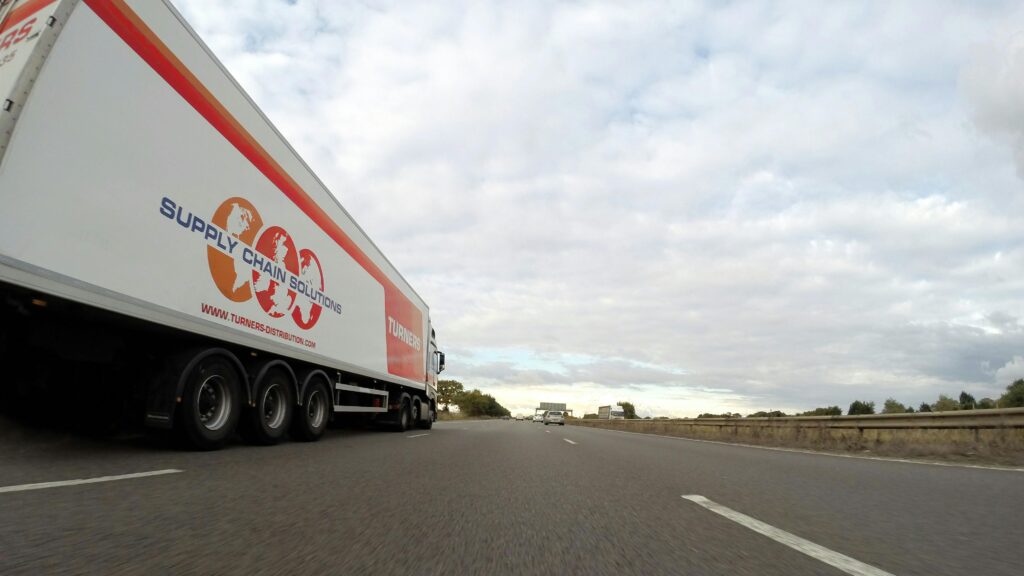 A picture of a semi truck in motion